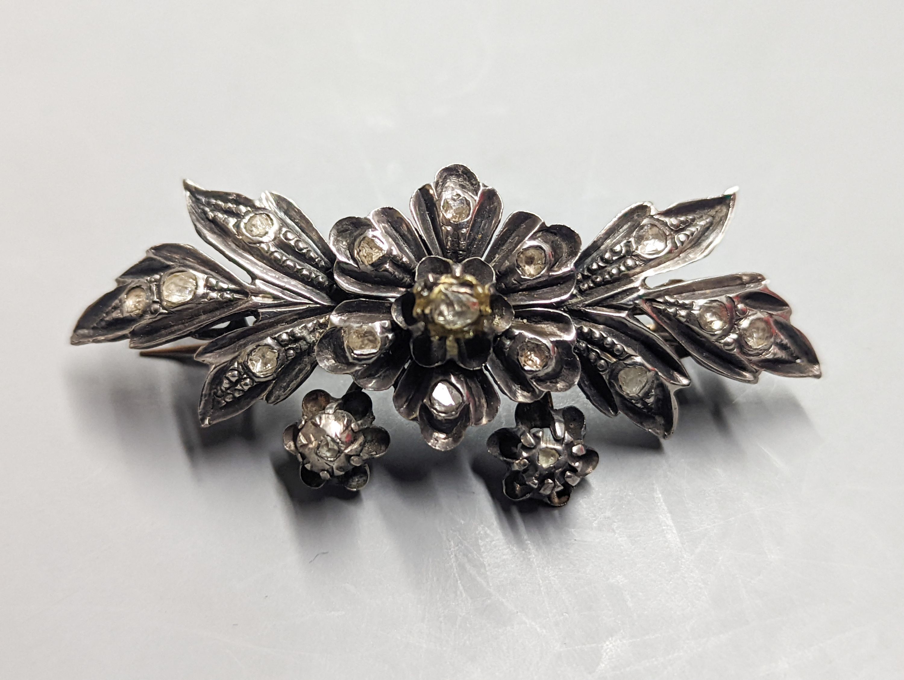 A 19th century continental white and yellow metal , rose cut diamond set floral spray brooch, 71mm, gross weight 21.7 grams.